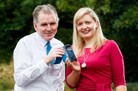 Picture of Amie Hynes Fitzpatrick and Stuart Lawler holding an iPhone